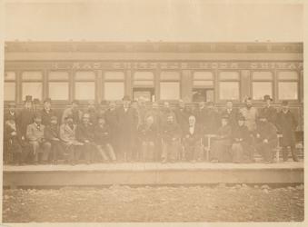 Group in front of a train car Photograph